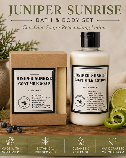 Juniper Sunrise Bath & Body Set featuring Goat Milk Soap and Goat Milk Lotion displayed on a rustic wooden surface with a kraft box, blueberries, lime slices, and greenery against a warm beige background.