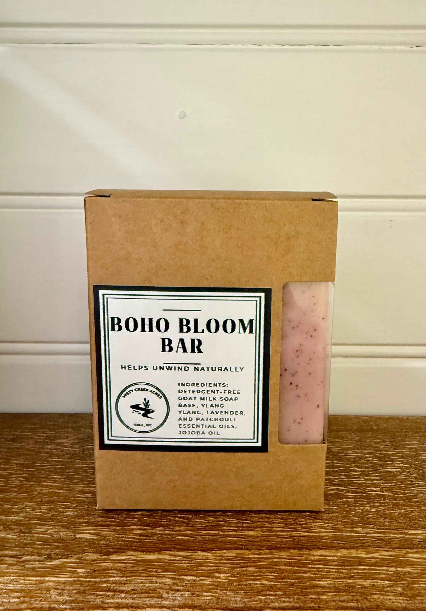 Boxed soap bar with 'Boho Bloom Bar' label on a wooden surface.