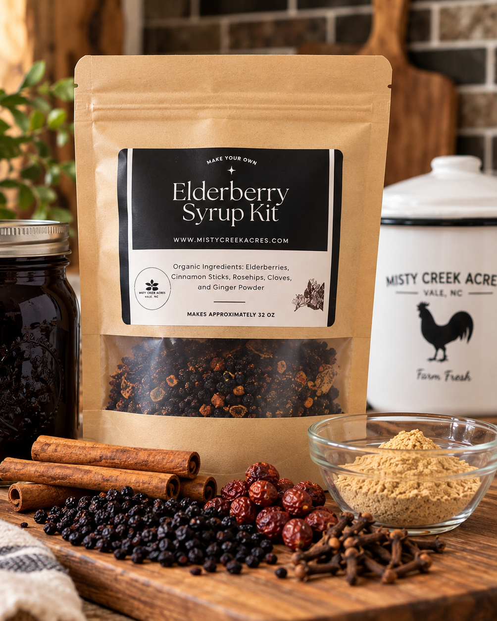 A stand-up pouch labeled Elderberry Syrup Kit stands on a wooden surface beside a glass jar filled with dark elderberry syrup, cinnamon sticks, dried berries, cloves, and a small bowl of powder. A real kitchen-like setting with plants and cabinetry is visible in the background, so this is Lifestyle rather than Product/Packaging.