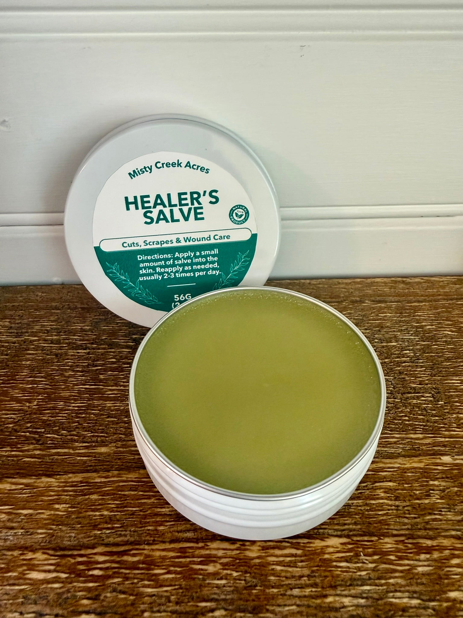 Healer's Salve container with lid on a wooden surface