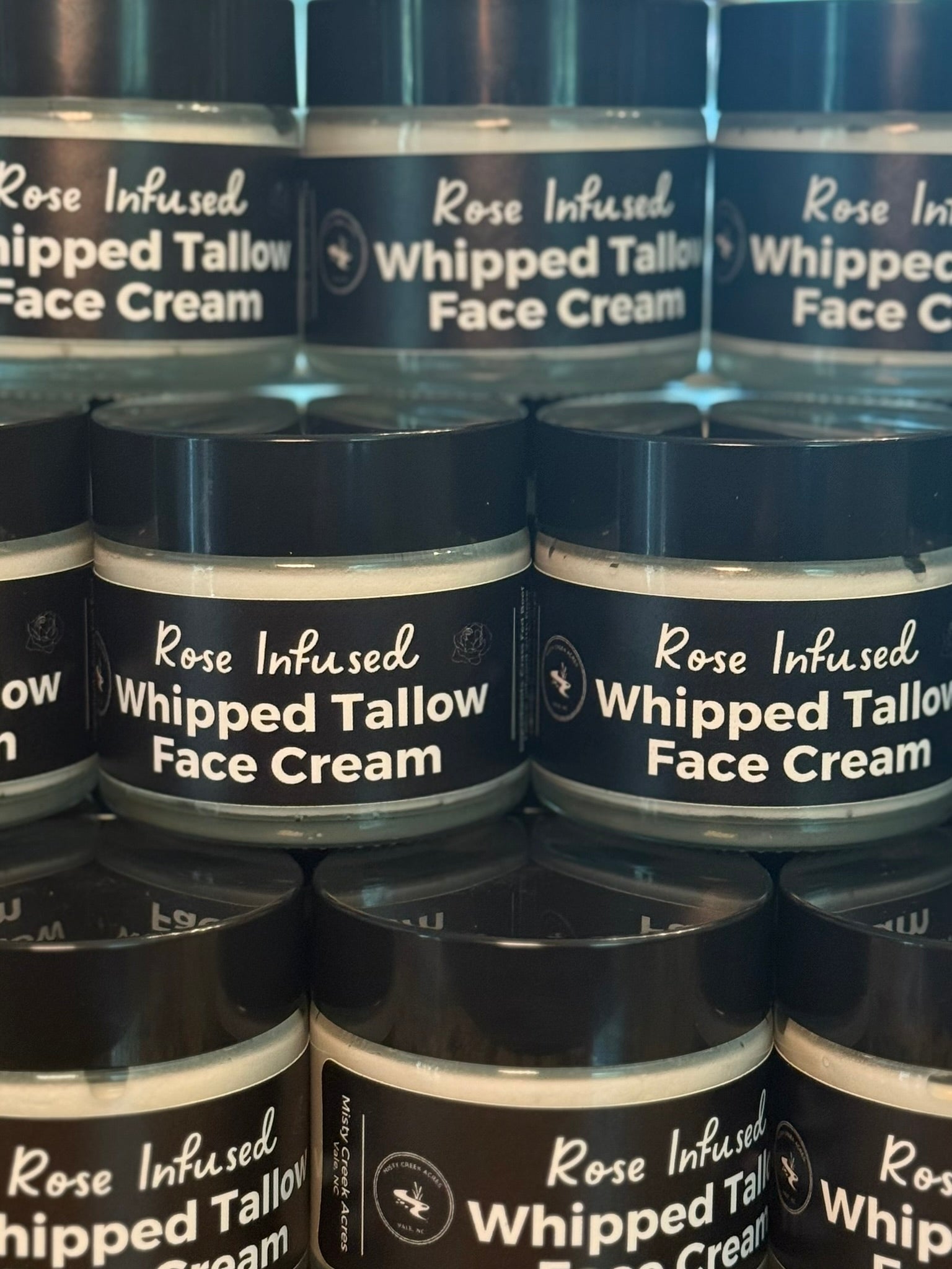 Multiple jars of Rose Infused Whipped Tallow Face Cream stacked together.