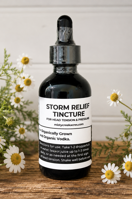 Bottle of Storm Relief Tincture with flowers on a wooden surface