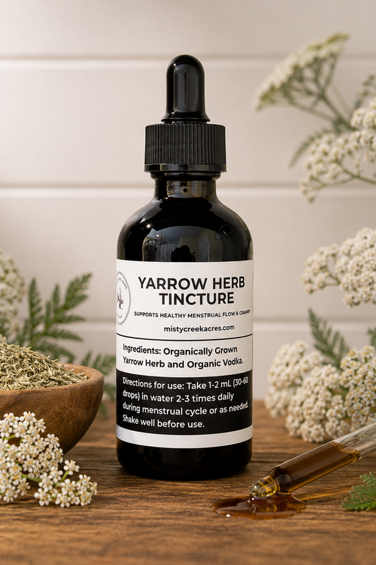 Yarrow herb tincture bottle with dropper on a wooden surface with yarrow flowers.