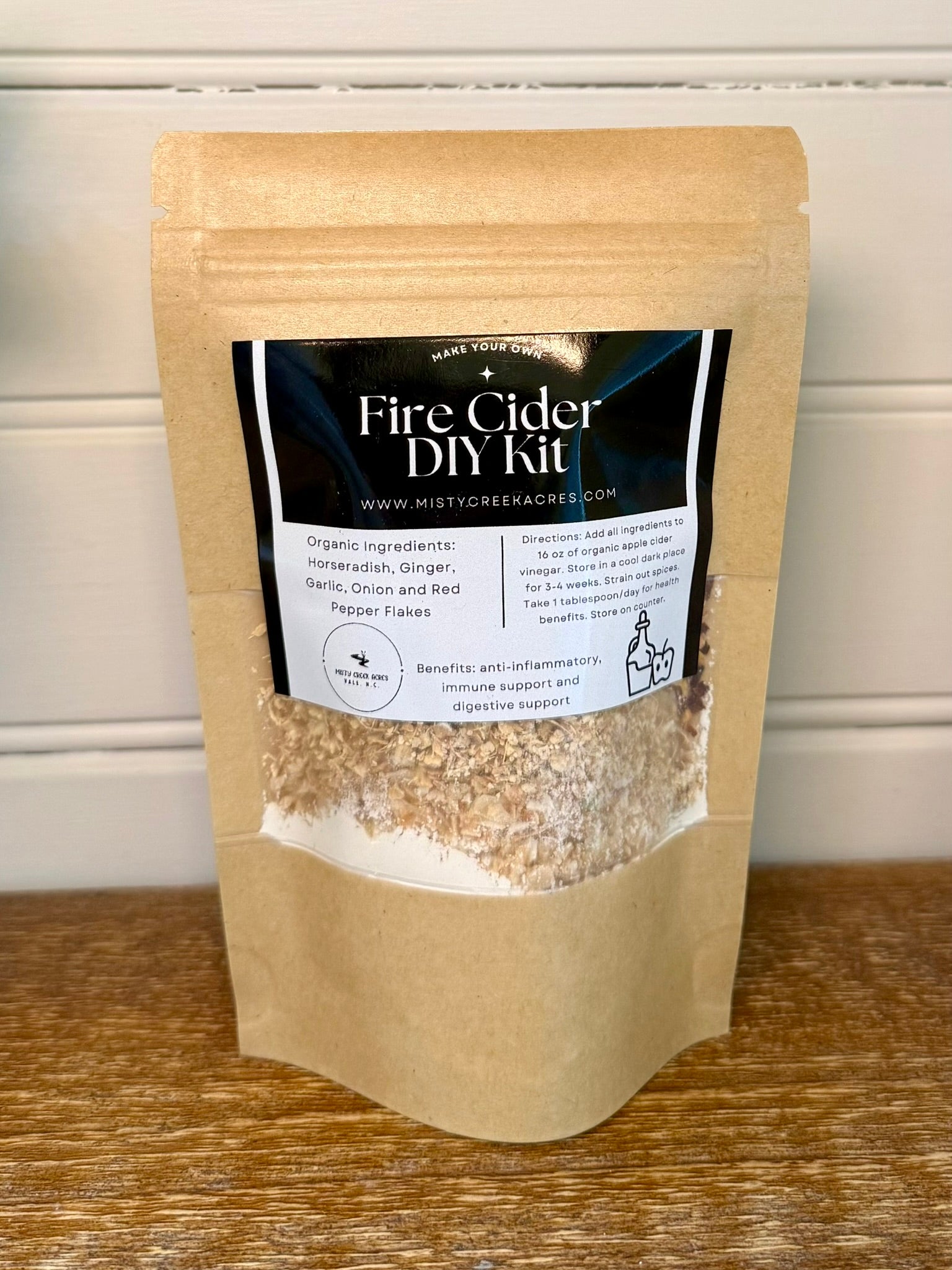 Fire Cider DIY Kit packaging on a wooden surface with a white background
