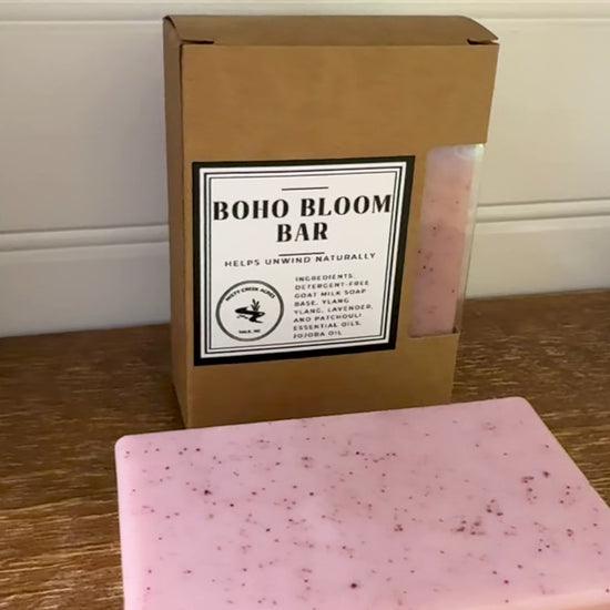 Boxed soap bar with 'Boho Bloom Bar' label on a wooden surface.