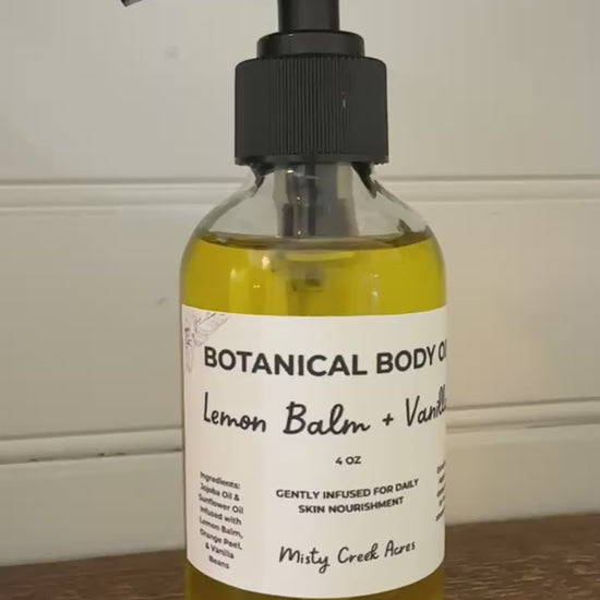 Bottle of botanical body oil with a pump on a wooden surface and white wall background