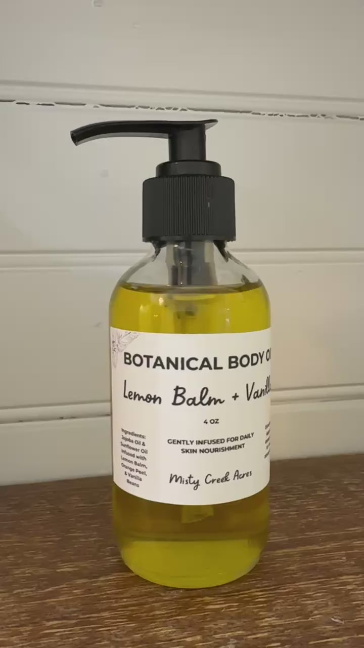 Bottle of botanical body oil with a pump on a wooden surface and white wall background