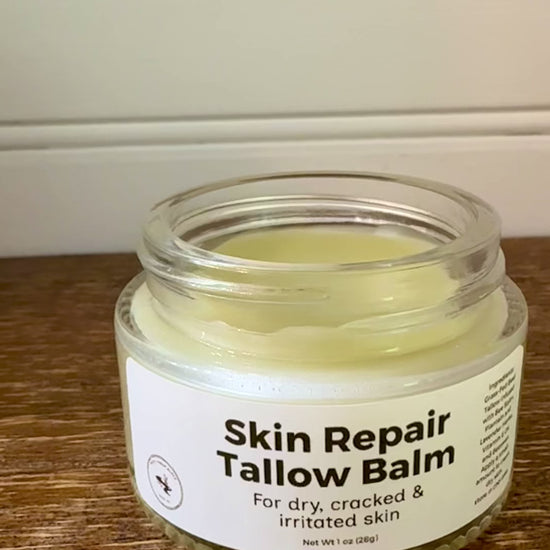 Jar of Skin Repair Tallow Balm on a wooden surface with a neutral background